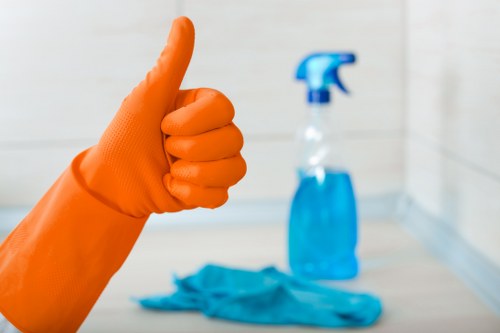 Local cleaner treating stains on a lounge sofa in Croydon